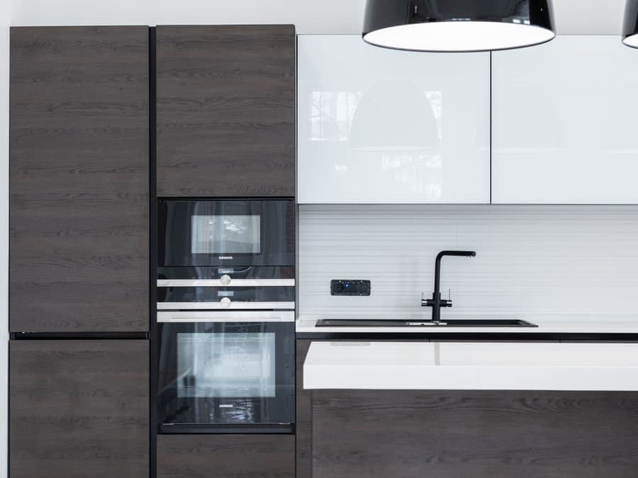 A remodeled modern kitchen with new cabinets and countertops